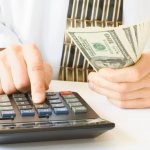 Hands, money, calculator